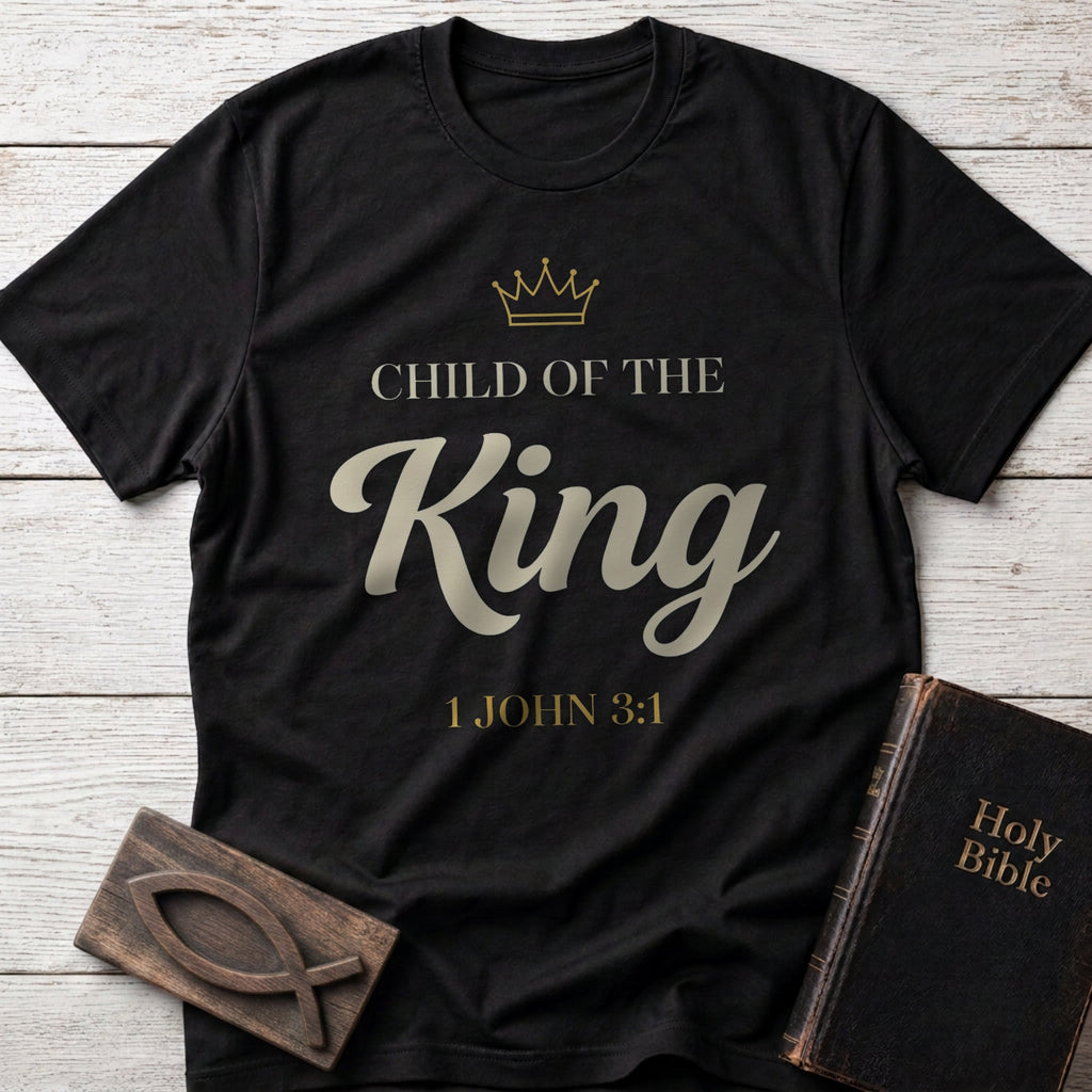 Child of the King t-shirt in Black — 1 John 3:1 Christian tee flat lay with Holy Bible and ichthys on whitewashed wood