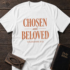Chosen and Beloved t-shirt in White — Colossians 3:12 Christian tee flat lay with Holy Bible and ichthys on dark wood