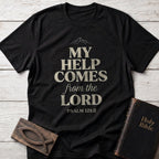 My Help Comes From the Lord t-shirt in Black — Psalm 121:2 Christian tee flat lay with Holy Bible and ichthys on whitewashed wood