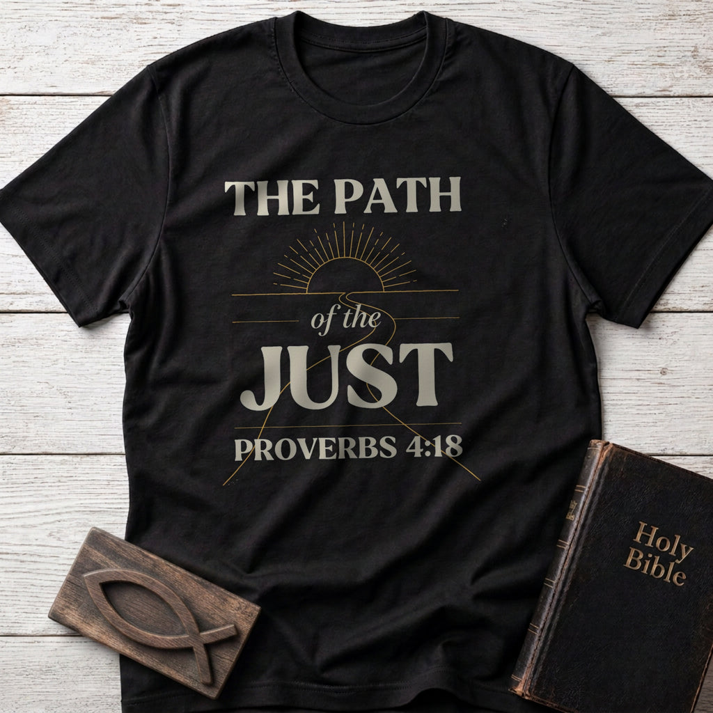 The Path of the Just t-shirt in Black — Proverbs 4:18 Christian tee flat lay with Holy Bible and ichthys on whitewashed wood