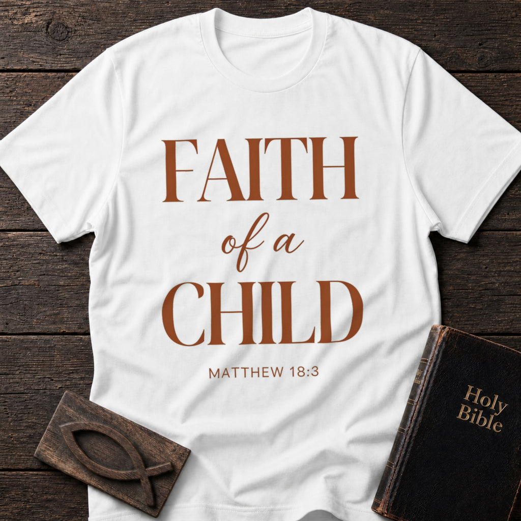 Faith of a Child t-shirt in White — Matthew 18:3 Christian tee flat lay with Holy Bible and ichthys on dark wood