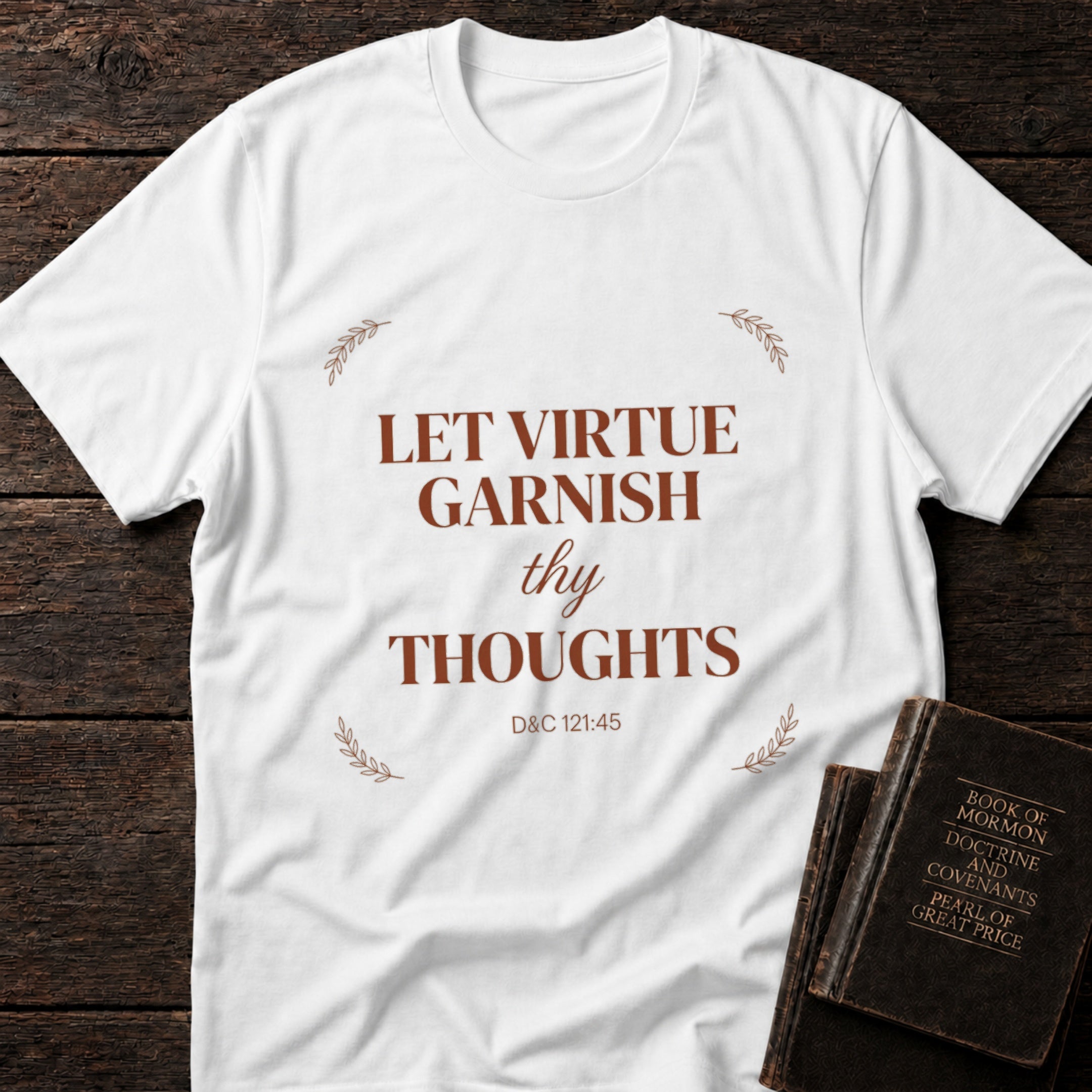 Let Virtue Garnish Thy Thoughts t-shirt in White — D&C 121:45 Christian tee flat lay with Book of Mormon scripture set on dark wood