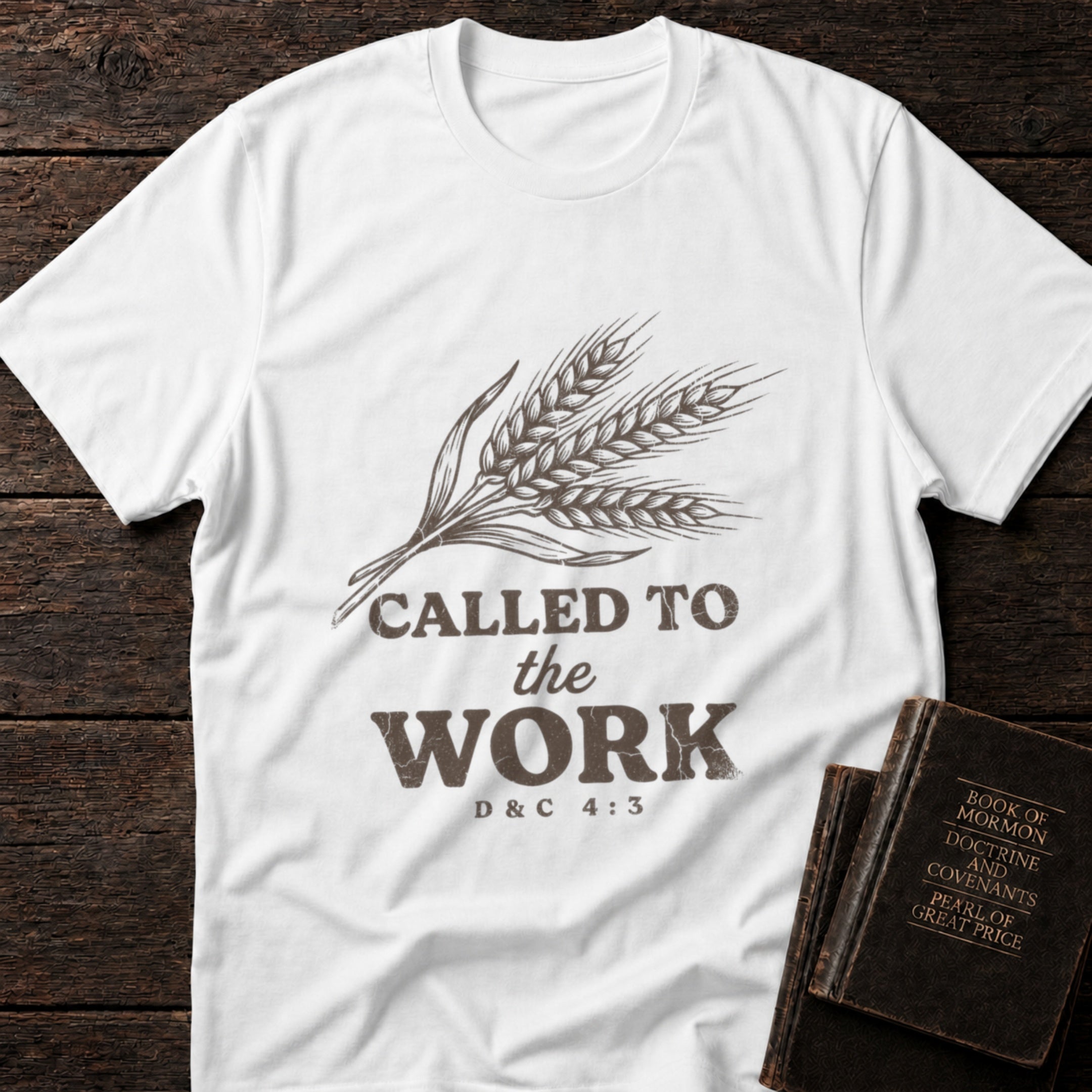 Called to the Work t-shirt in White — D&C 4:3 missionary tee flat lay with scripture books on dark wood