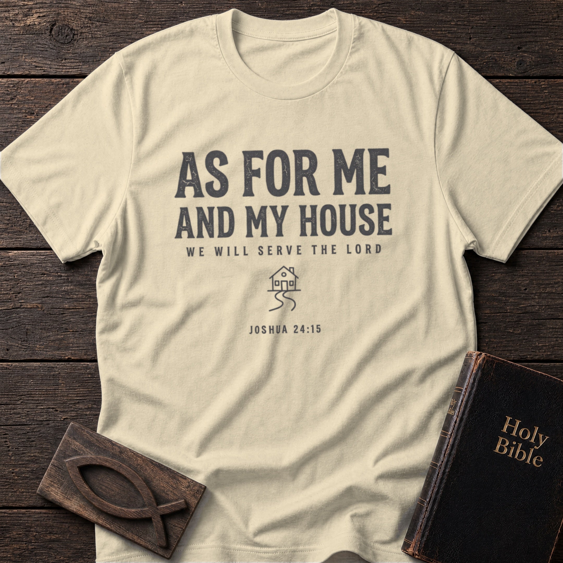 As For Me and My House t-shirt in Natural — Joshua 24:15 Christian tee flat lay with Holy Bible and ichthys on dark wood