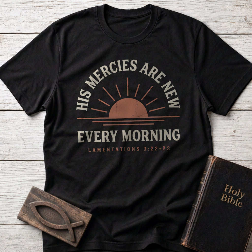 His Mercies Are New Every Morning t-shirt in Black — Lamentations 3:22–23 Christian tee flat lay with Holy Bible and ichthys on whitewashed wood